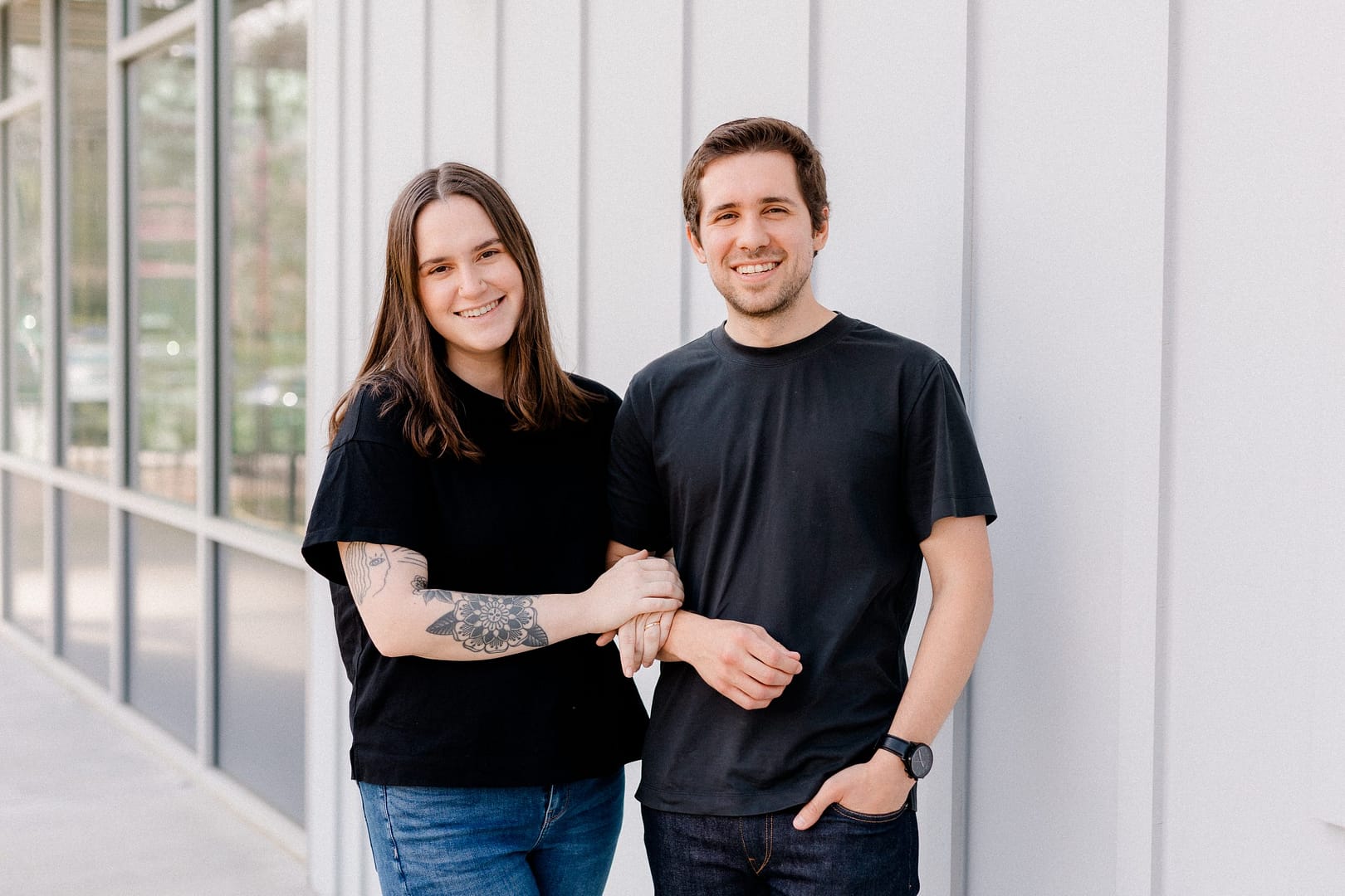 barefoot Alison and Taylor Barefoot smiling sitting portrait for Barefoot Build team