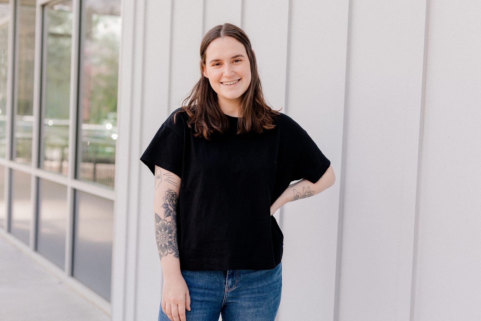 Hip Co-owner Alison stands outside with her hand on her hip smiling