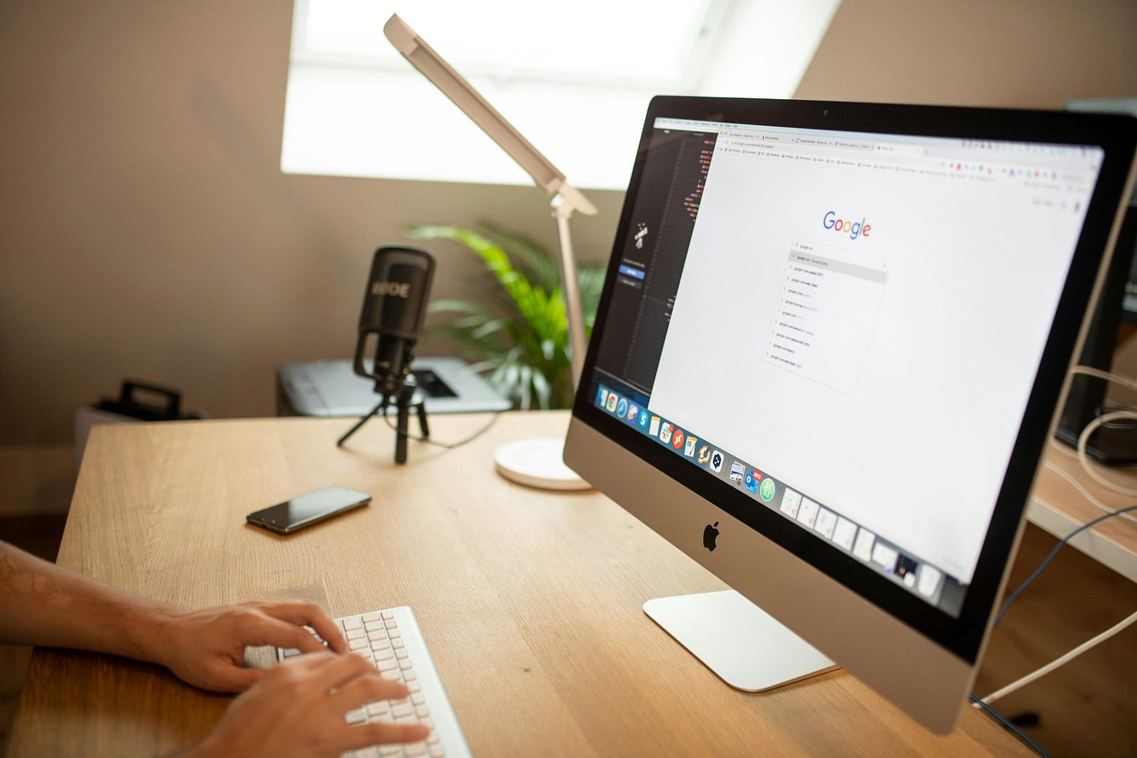 Man enters a search query into google in a naturally lit room
