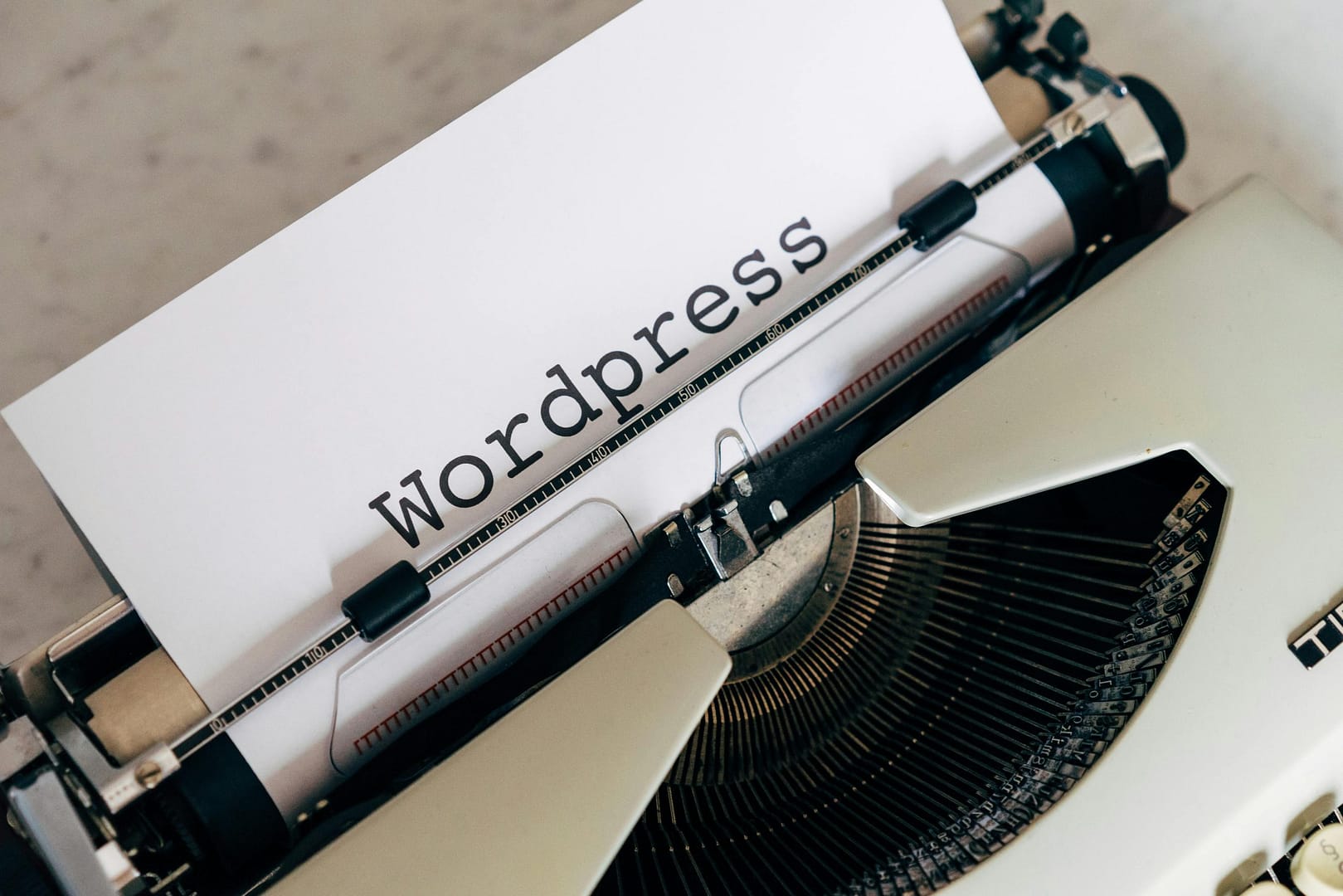Typewriter writing WordPress representing owning your website and WordPress backups